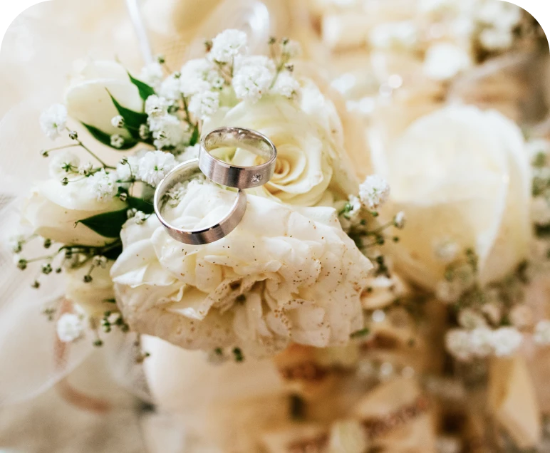 Silver rings atop bridal bouquet