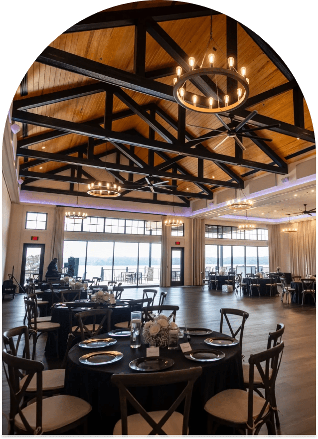 Spacious banquet hall with elegant wooden ceiling.