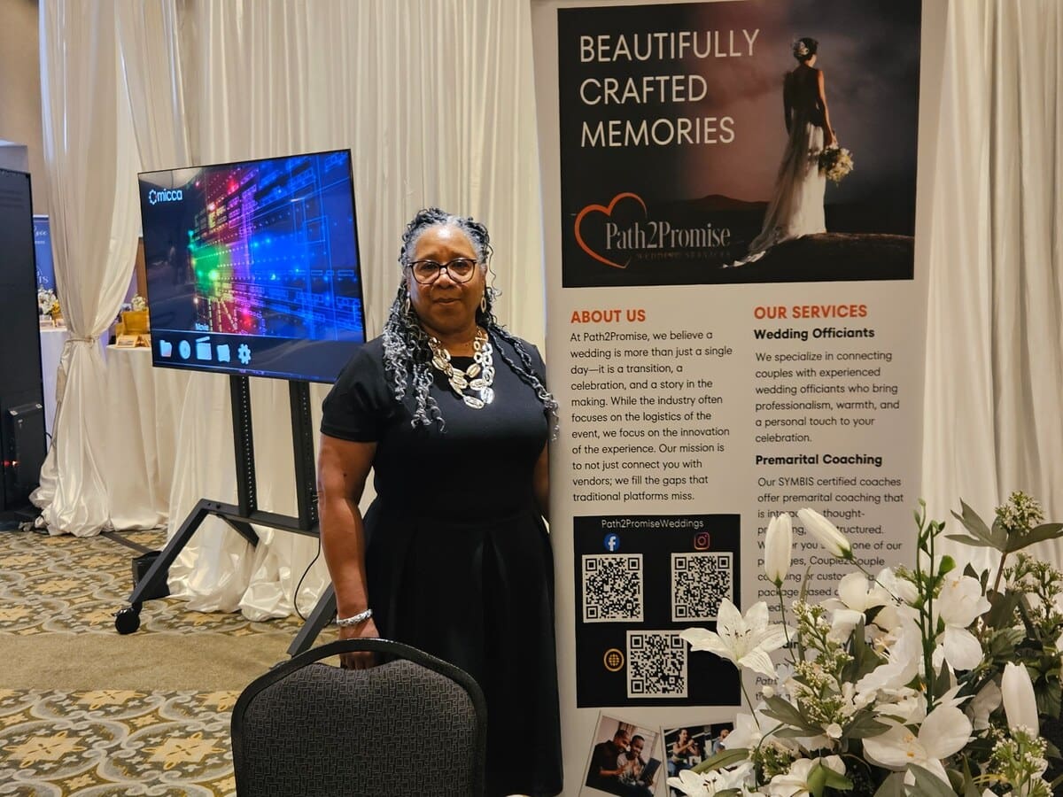 Path2Promise representative beside the company display at a Georgia bridal expo